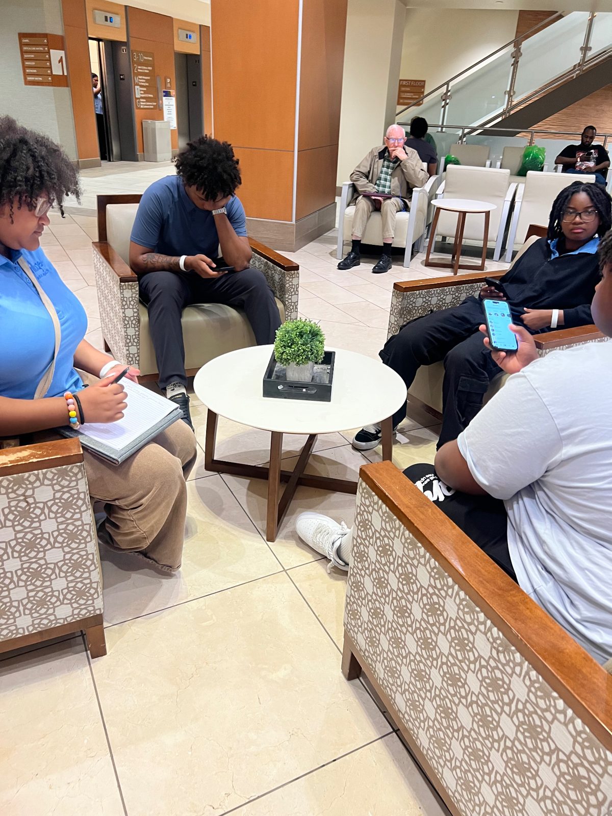Summer Institute students in a small group discussion during a field visit